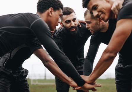Sporting teammates huddle together
