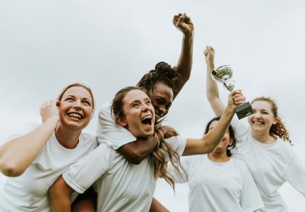 A group of soccer players celebrate together