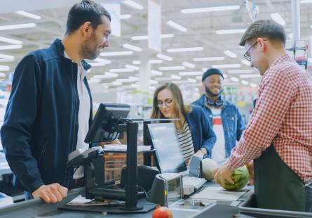 People standing in line at a supermarket cashier