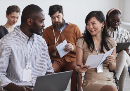 A group of business people engage in conversation sitting down
