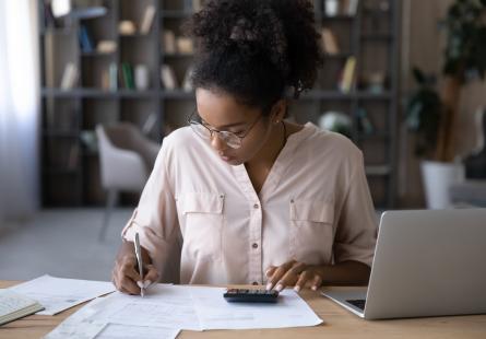 A woman sits working at her computer