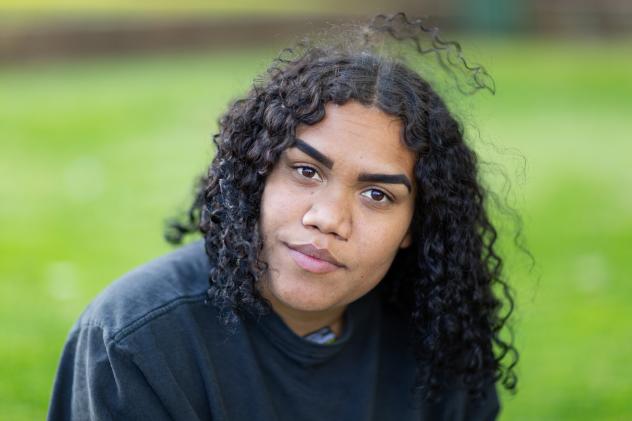 Young First Nations woman looking intently at camera